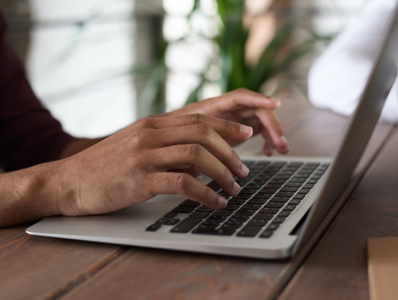 View of a person's hands using a computer