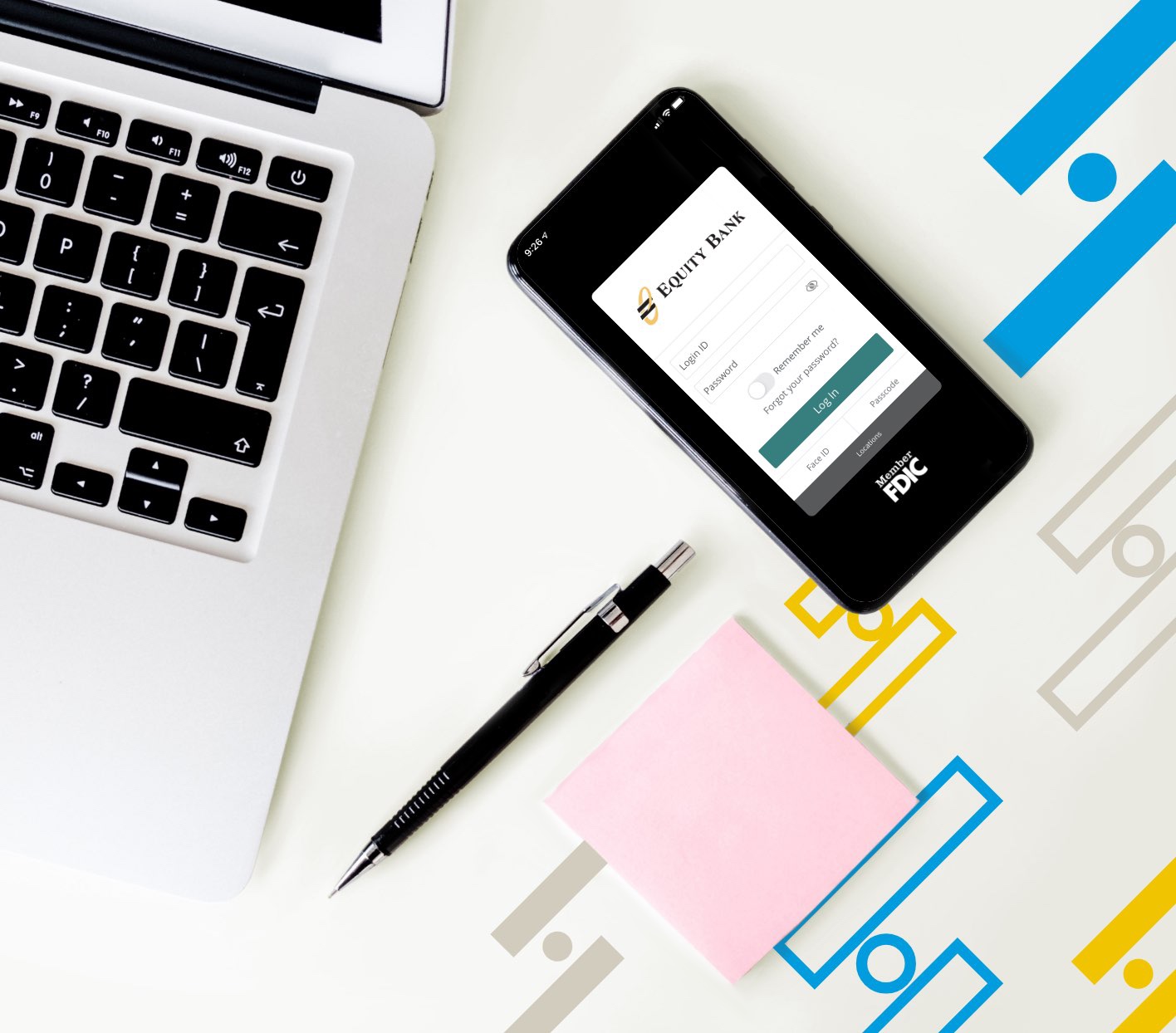 Aerial view of the phone, pen, post-it pad and laptop.