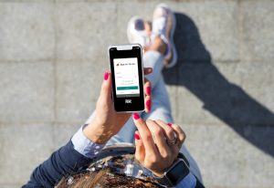 Woman holding phone with Equity Bank app on the screen