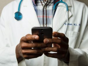 Doctor's hands holding a cell phone