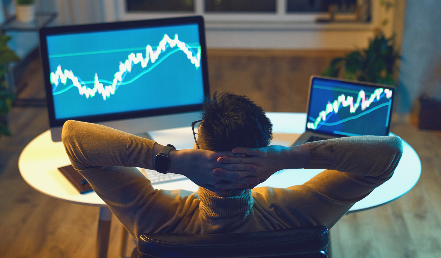 Man Staring at Computer Screens with Graphs on them