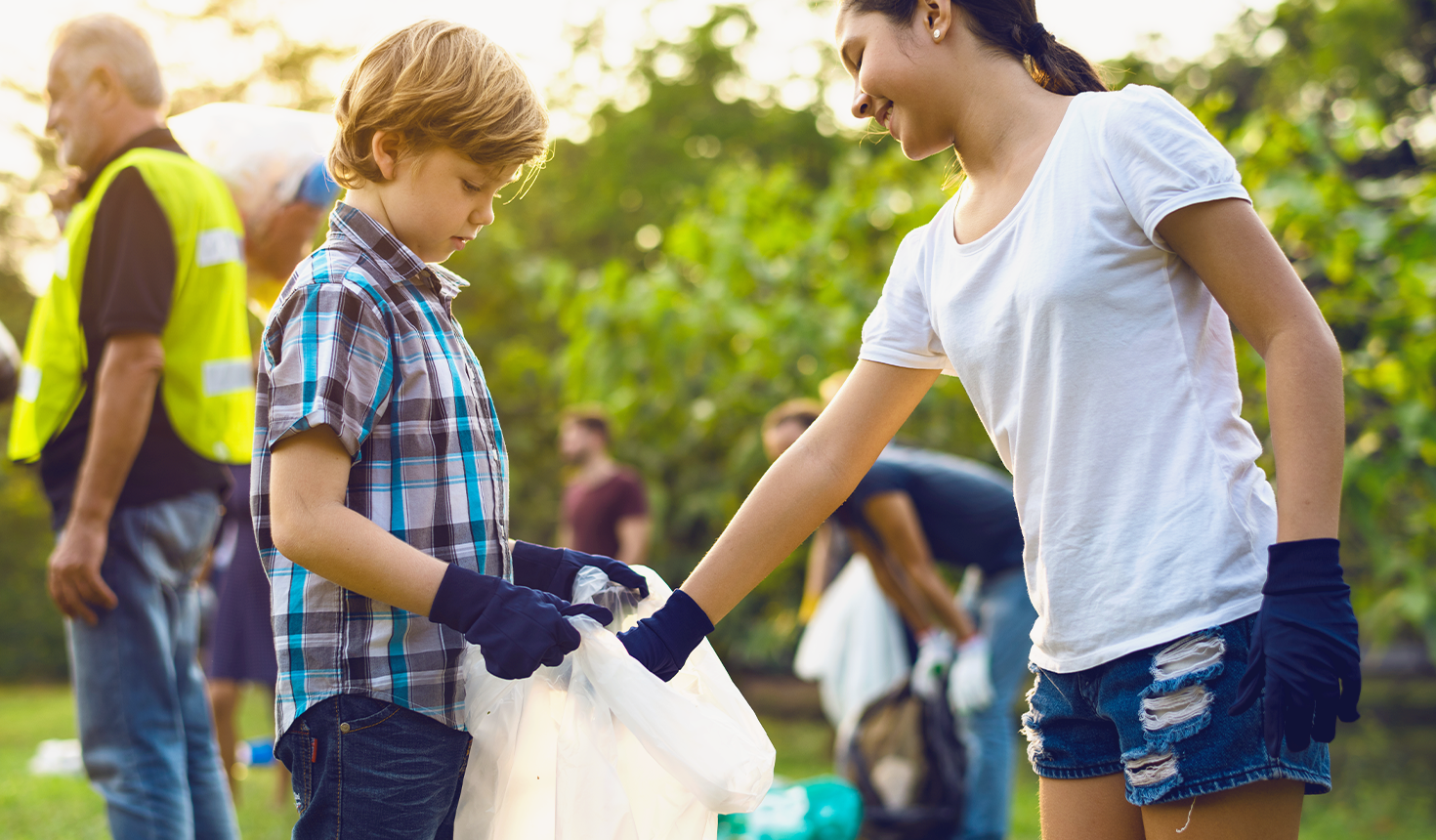 Girl and Boy Picking up Trash and Helping Eachother