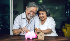 Old Couple Putting Money into Bank