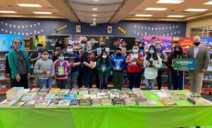 Kids at a Book Fair holding their books