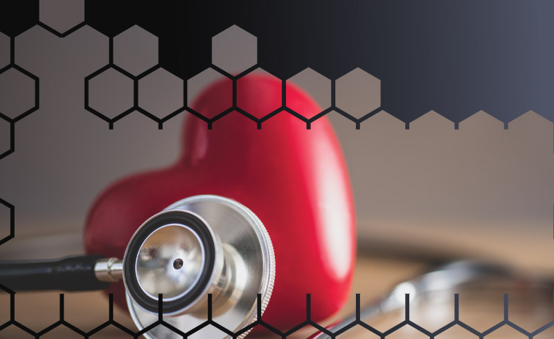 A stethoscope and a heart on a table.
