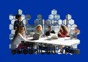 A team of people sits at a conference table during a meeting.