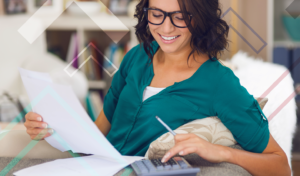 Girl calculating her mortgage on paper with a calculator