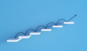 Arrow bounding up a set up stairs.