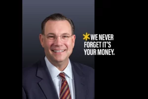 A portrait of CEO Brad Elliott with the text "*WE NEVER FORGET, IT'S YOUR MONEY." superimposed.