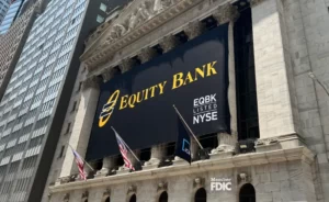 The front of the New York Stock Exchange, with a black banner bearing the Equity Bank logo and white text that reads "EQBK LISTED NYSE".