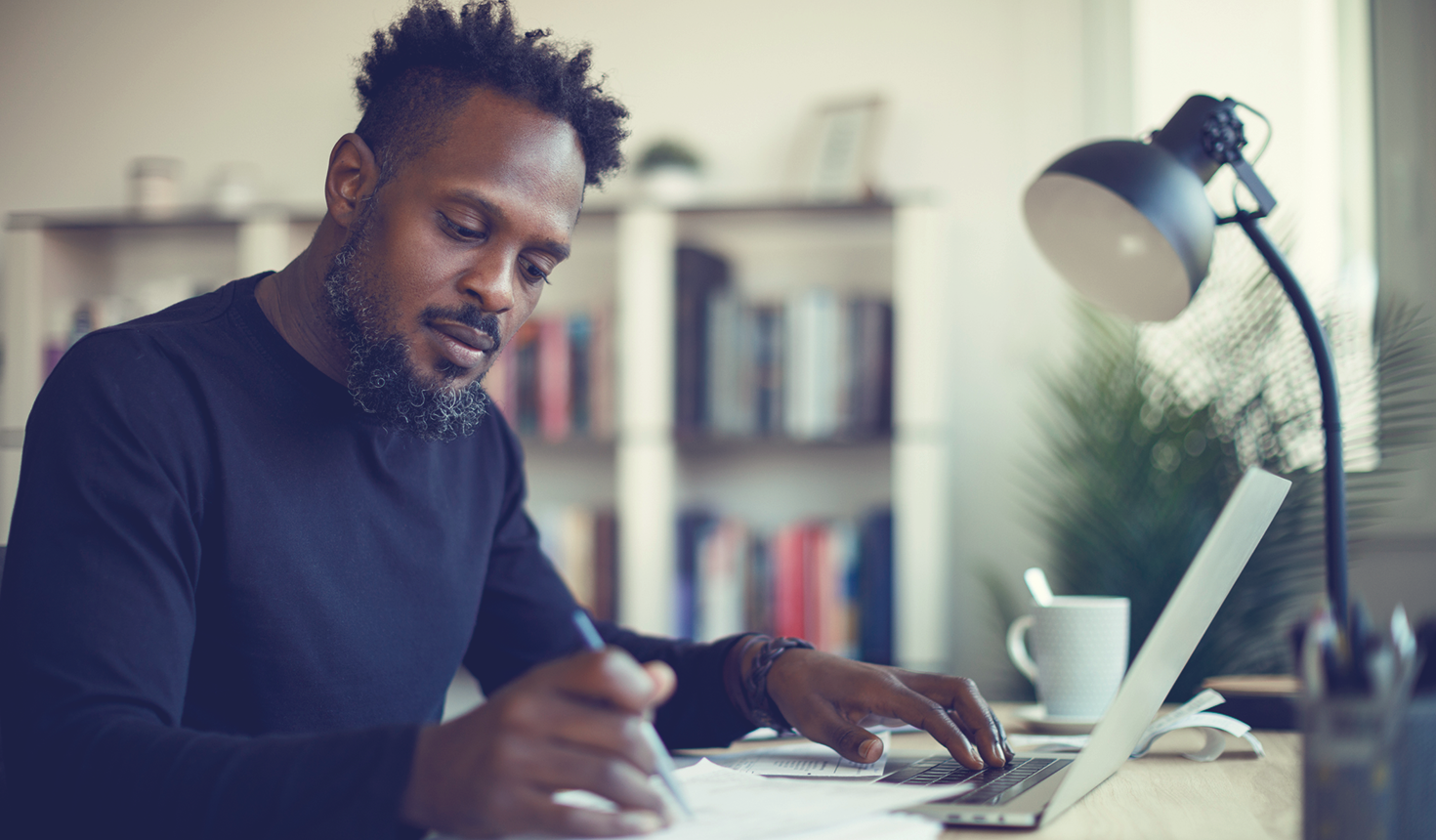 Man sitting at a desk trying to budget