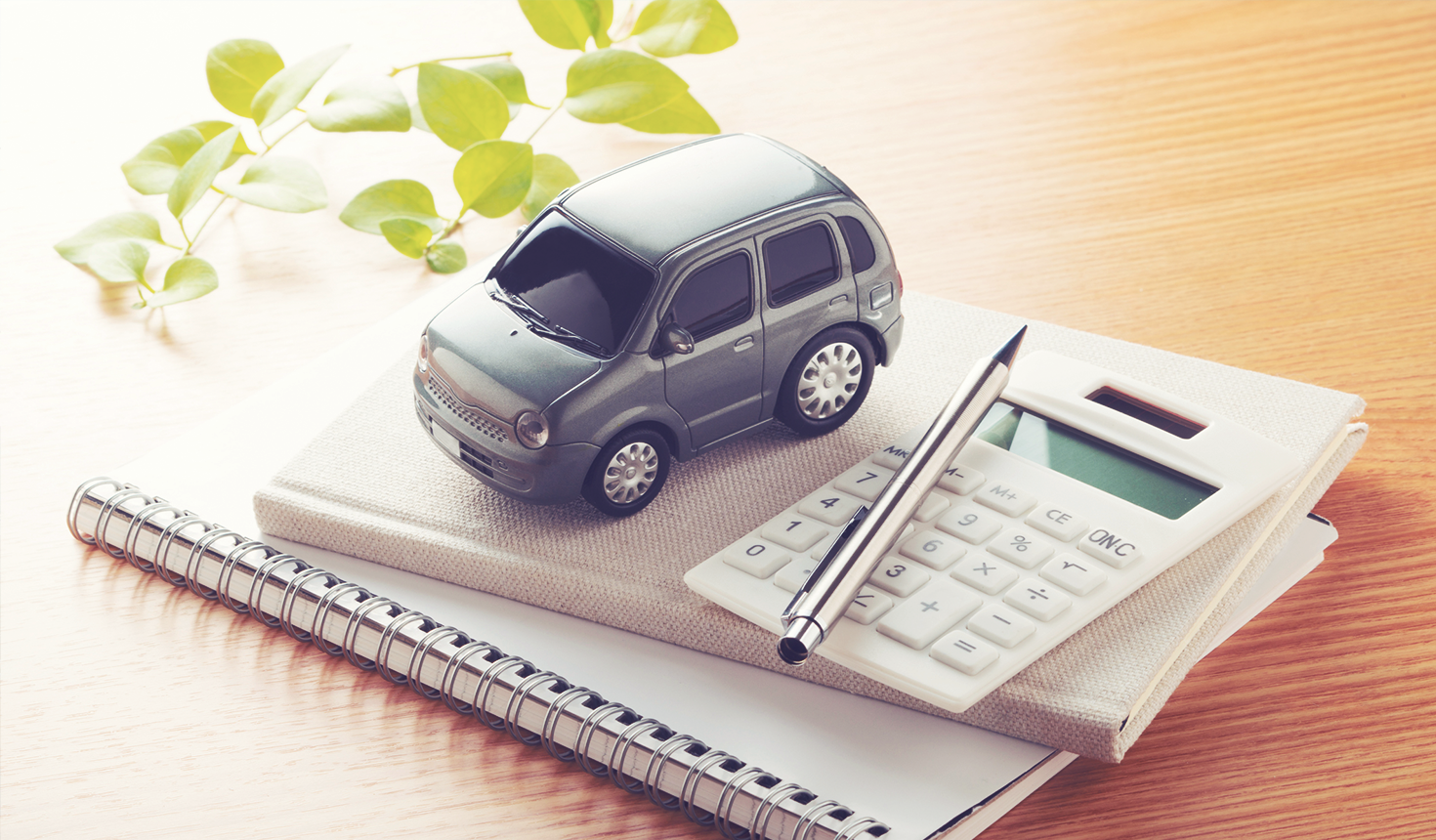 Toy car and calculator on paperwork