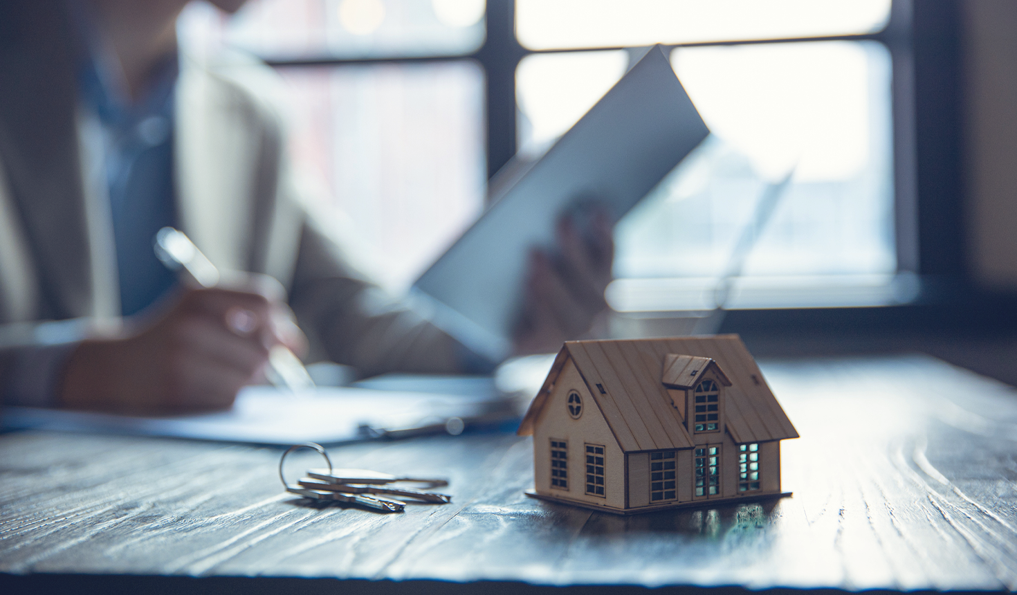 Toy House with Person doing Paperwork