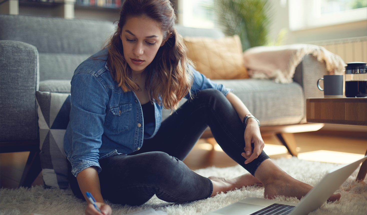 Student with Laptop and Notepad