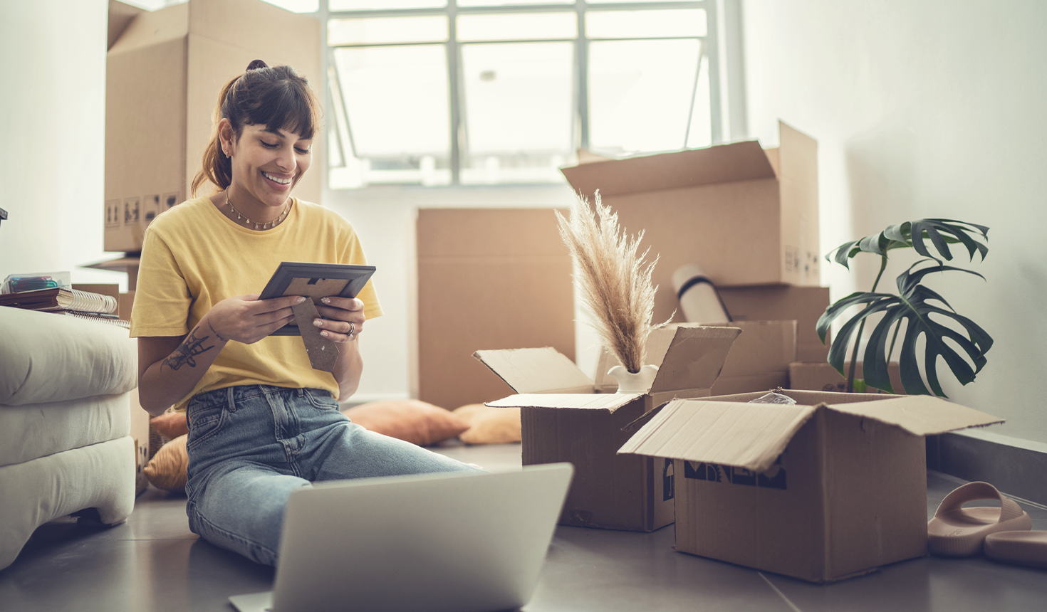 Girl unpacking boxes and moving into a new home.