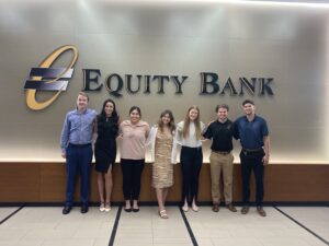 Group of interns standing in front of the Equity Bank sign