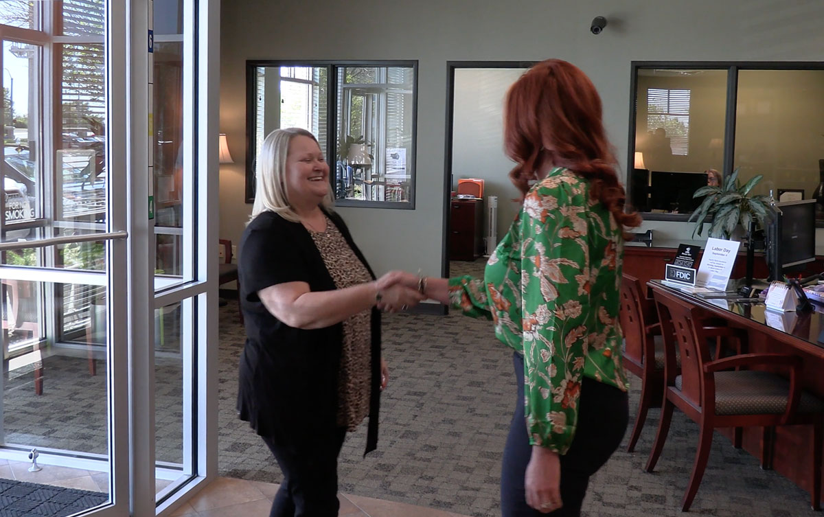 Blue Springs customer shaking hands with Equity Bank team member.