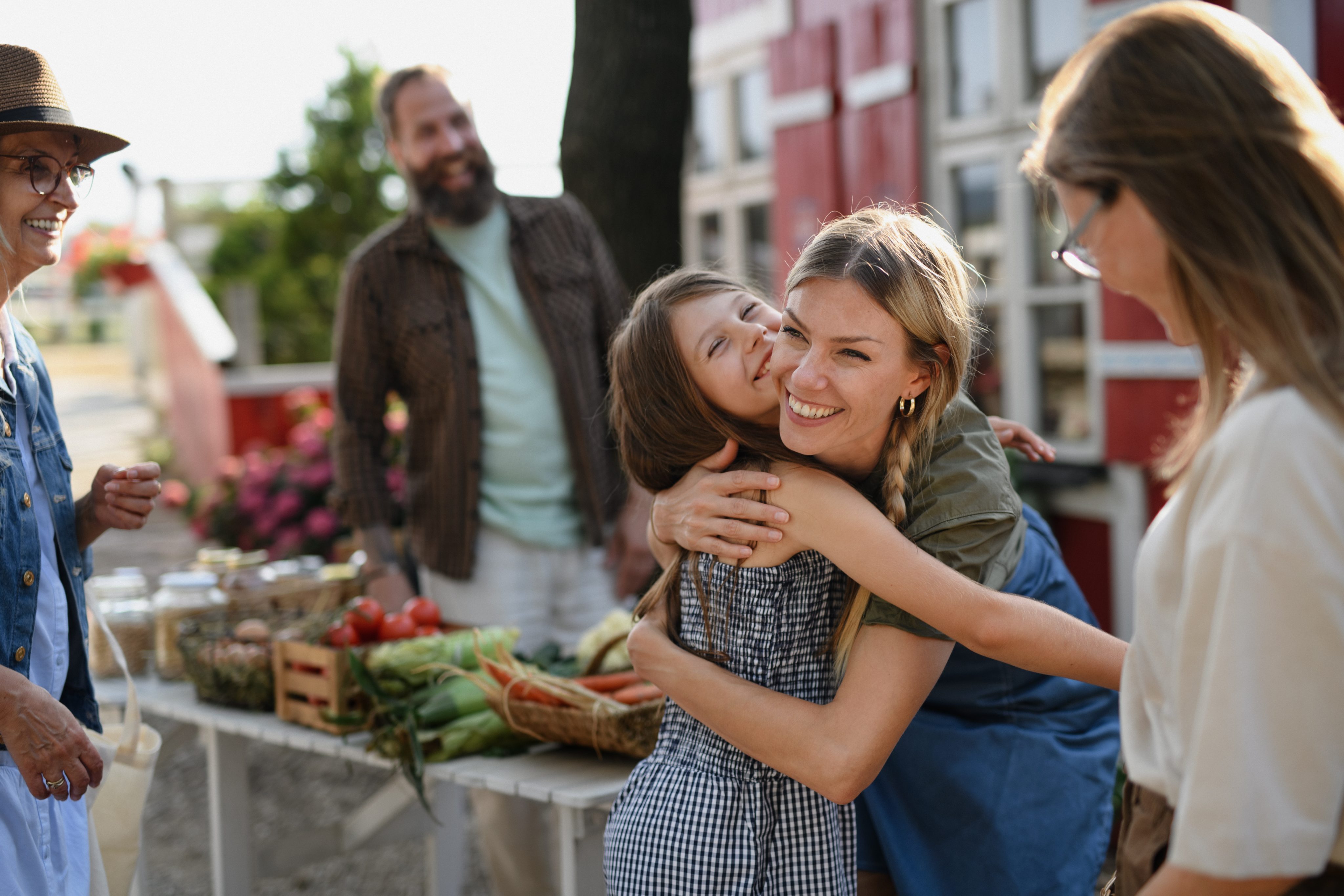 garden city, ks girl hugging mother at farmers market