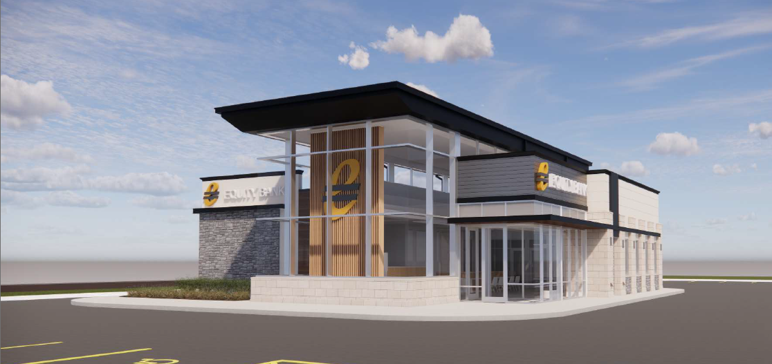 Exterior of a modern bank branch with glass walls, stone accents, and a large yellow circular logo on the facade under a blue sky.